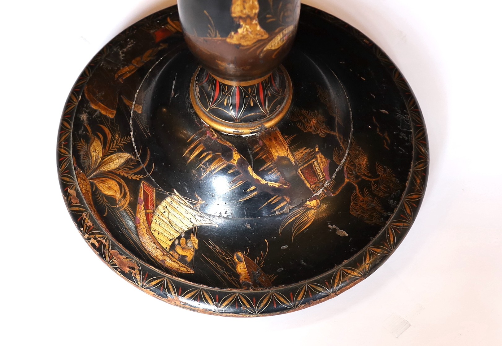 A 1920s English chinoiserie lacquered lamp standard, decorated with gilt figures in boats and flowers on a black ground, height 164cm. width of base 38cm